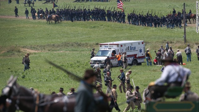 An ambulance, taking several people away due to heat exhaustion, departs the area on June 30. 