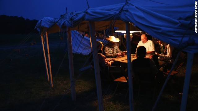 Reenactors play poker while on break during the three-day event on June 29.