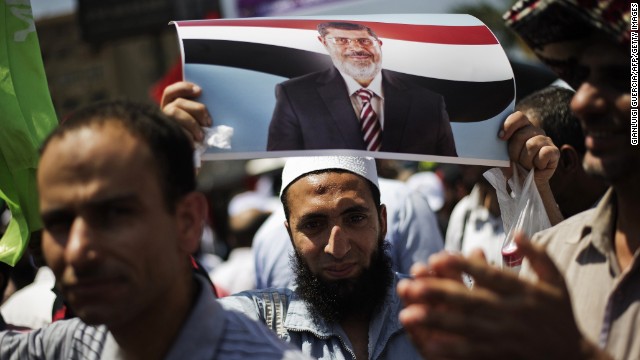 An Egyptian protester holds a picture of President Mohamed Morsy as Islamists and Muslim Brotherhood supporters gather at the Rabaa al-Adawiya mosque to start an open-ended sit-in in support of Morsy's legitimacy in Cairo on June 28, 2013. 