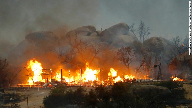 Homes burn on Sunday, June 30, in Glenn Ilah, Arizona, near Yarnell.