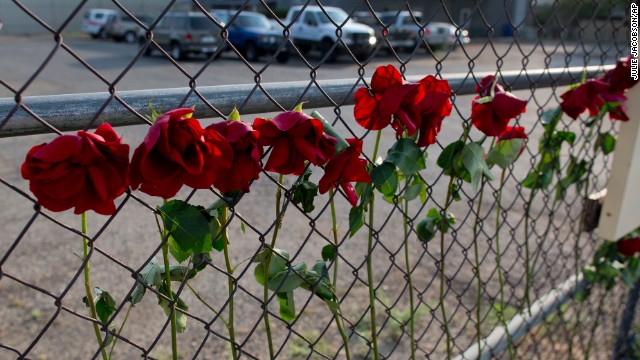 Flowers hang on the fence outside the Granite Mountain Hot Shot Crew fire station on July 1.