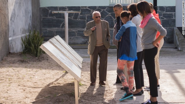Ahmed Kathrada, a former fellow prisoner with Nelson Mandela, shows the Obama family around Robben Island in Cape Town, South Africa, on Sunday, June 30. The island, where prisoners were banished and isolated during the apartheid era, is now a museum.