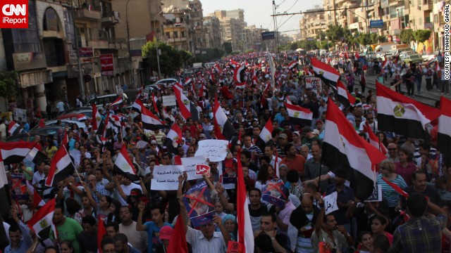 <a href='http://ireport.cnn.com/docs/DOC-997711' />iReporter MahmoudGamal attended Sunday's protests in Cairo against President Mohamed Morsy and his government. His photos capture the vibrancy of the protests -- from a dog wearing an anti-Morsy shirt to protesters waving red cards like referees in a football game, calling on Morsy to resign.