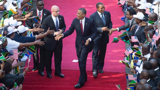 U.S. President Barack Obama and Tanzanian President Jakaya Kikwete, right, are greeted by a cheering crowd as they arrive at the State House in Dar es Salaam, Tanzania, on Monday, July 1.