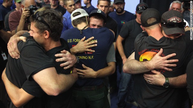Local firefighters embrace July 1 at a Prescott, Arizona, memorial service for the 19 firefighters killed in the Yarnell Hill Fire, northwest of Phoenix.