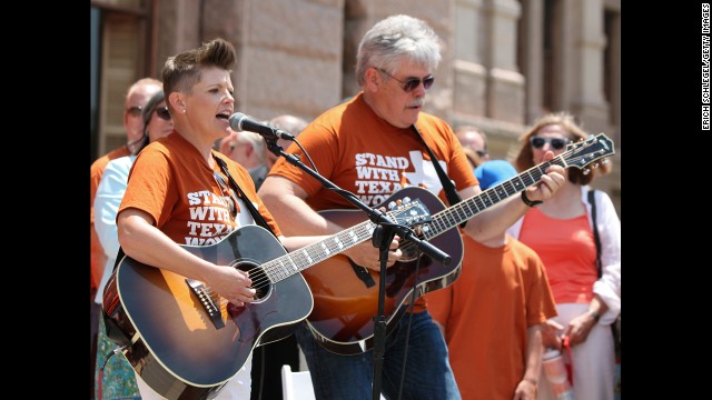 Natalie Maines and her father Lloyd Maines play the National Anthem at a rally supporting women's right on July 1.