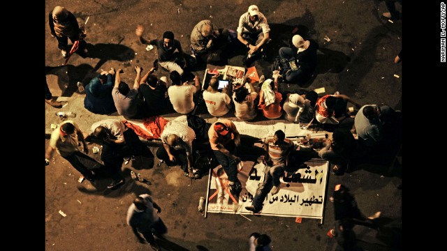 Morsy opponents sit on a banner outside the presidential palace on June 30. State-funded Egyptian daily Al-Ahram has reported 46 sexual assaults during anti-Morsy protests in Egypt since June 30.