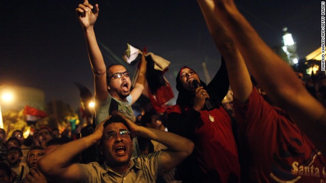 Protesters react after Morsy's speech in a street leading to the presidential palace in Cairo early on July 3. Morsy's angry opponents met head-on overnight with his supporters at Cairo University, leaving 23 people dead. 