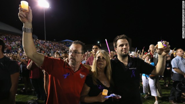 People hold up lights and candles on July 2.