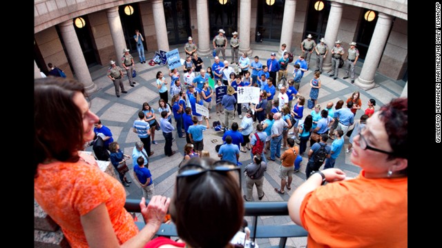 Abortion rights activists Melissa Gabriel, Ally Parks and Tina Johnson look over anti-abortion demonstrators on July 2.