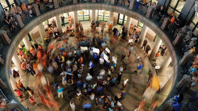 Opponents of an abortion bill walk in circles around supporters of the bill as a committee holds hearings on the bill at the Texas Capitol in Austin, Texas, on Tuesday, July 2. Gov. Rick Perry called a second legislative special session in an effort to pass a restrictive abortion law through the legislature. The first attempt was defeated after opponents were able to stall the vote until after the first special session had ended. A final vote is expected next week.