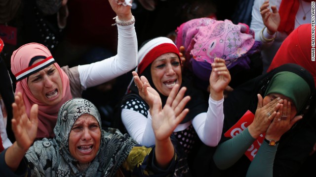 Women react to the flag-draped body of a victim (not pictured) who was killed during fighting outside Cairo University on July 3.