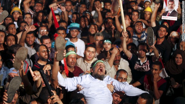 Members of the Muslim Brotherhood and Morsy supporters react at the Raba El-Adwyia mosque square on July 3 after the Egyptian Army's statement was announced on state TV.