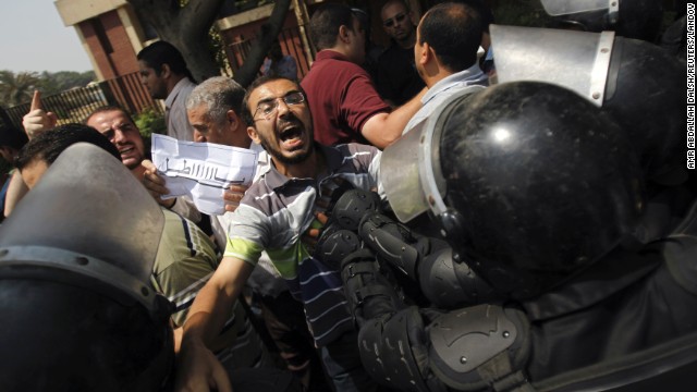 Members of the Muslim Brotherhood and supporters of ousted Egyptian President Mohamed Morsy clash with riot police during the swearing in ceremony of Adly Mansour as interim president in Cairo on Thursday, July 4. Egypt's military deposed Morsy, the country's first democratically elected president, the country's top general announced Wednesday. <a href='http://www.cnn.com/2013/07/04/middleeast/gallery/egypt-after-coup/index.html'>View photos of Egypt after the coup.</a>