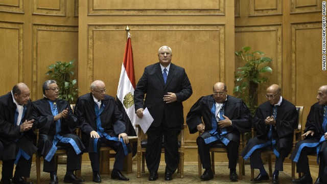 Adly Mansour, center, stands after delivering a speech during his swearing-in ceremony as Egypt's interim president in the Supreme Constitutional Court in Cairo on July 4. Mansour has served as the head of the country's Supreme Constitutional Court.