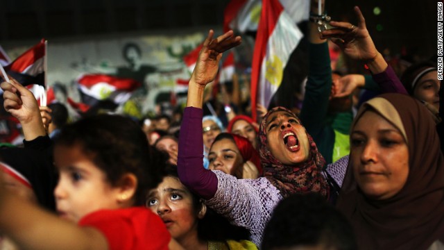People dance and cheer in the streets of Cairo on July 4.