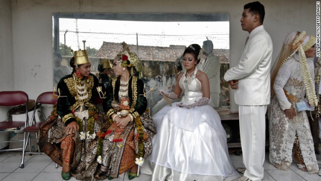 Bride and groom couples prepare for marriage during a mass wedding ceremony on December 12, 2012 in Yogyakarta, Indonesia. Twelve couples participated in a mass wedding as that day saw a surge in marriage across the globe to mark the once in a century date of 12/12/12.