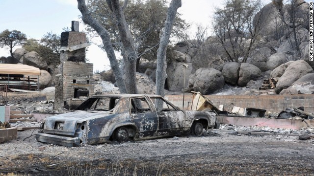 A deadly wildfire leaves behind little but a burned-out car and the remains of a house in a Yarnell, Arizona, neighborhood on Wednesday, July 3. The fire started a week ago near Yarnell, apparently because of lightning strikes. <a href='http://www.cnn.com/interactive/2013/07/us/yarnell-fire/index.html' target='_blank'>Nineteen firefighters were killed</a> Sunday, June 30, battling the blaze northwest of Phoenix. 