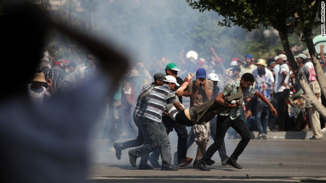 Morsy supporters carry a man who was shot during clashes next to the Republican Guard headquarters in Cairo on July 5. State broadcaster Nile TV said a number of those backing the deposed leader were wounded as they tried to storm the headquarters, where Morsy reportedly was being held.