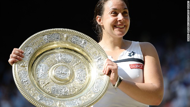 Marion Bartoli with the Venus Rosewater Dish. The 28-year-old claimed her first Grand Slam singles title with victory over Germany's Sabine Lisicki at Wimbledon on Saturday. 