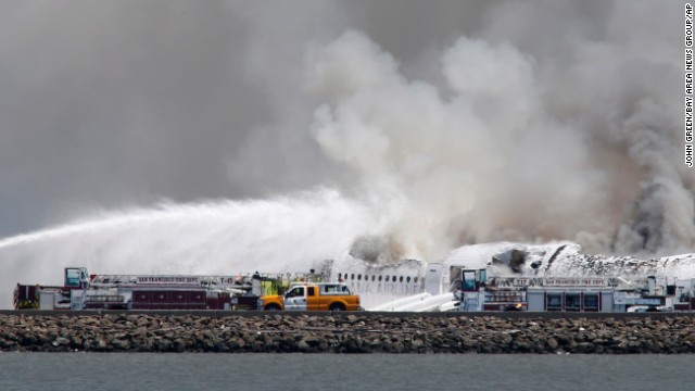 Fire crews work at the crash site at San Francisco International Airport on July 6.