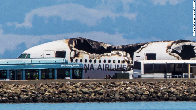 Airport shuttles arrive on the scene after the crash landing.