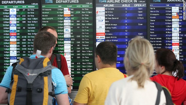 Travelers at San Francisco International Airport look at the departures and arrivals board after Asiana Flight 214 crashed on July 6. The airport, located 12 miles south of downtown San Francisco, is California's second busiest, behind Los Angeles International.