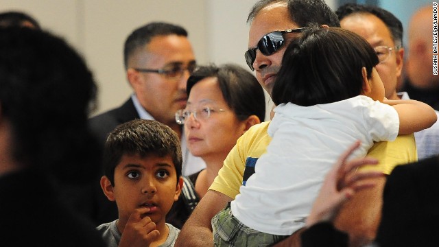 People are escorted from the Reflection Room at the San Francisco International Airport on July 6.