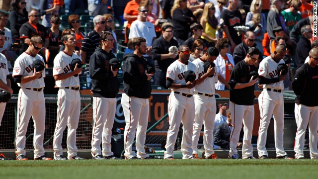 The San Francisco Giants observe a moment of silence for those killed and hurt in the crash before their baseball game on July 6 against the Los Angeles Dodgers at AT&T Park in San Francisco.