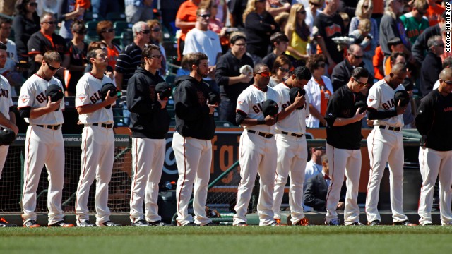 The San Francisco Giants observe a moment of silence for those killed and hurt in the crash before their baseball game on July 6 against the Los Angeles Dodgers at AT&amp;T Park in San Francisco.