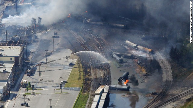 Firefighters work to put out fires at the wreckage of the train in Lac-Megantic on July 6.