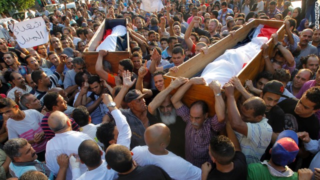 People carry coffins on July 6 of two Morsy opponents who were killed during clashes in Cairo.