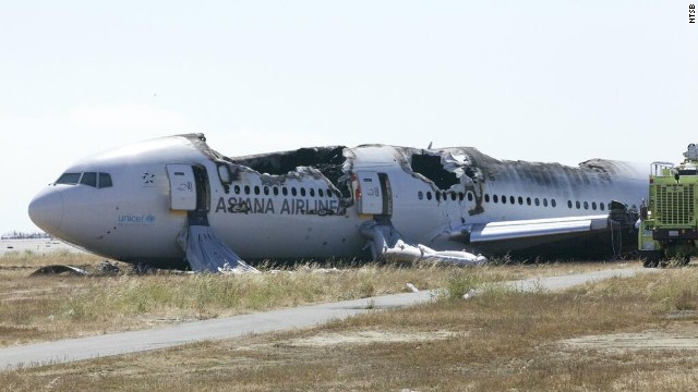 Asiana Airlines Flight 214 sits just off the runway at San Francisco International Airport on Sunday, July 7, in a handout photo from the National Transportation Safety Board. The Boeing 777 coming from Seoul, South Korea, crashed on landing on Saturday, July 6. 