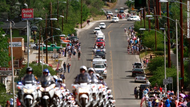 Nineteen white hearses carried the remains of the firefighters on July 7. They were accompanied by police motorcycle outriders on a final journey passing through the crew's hometown.