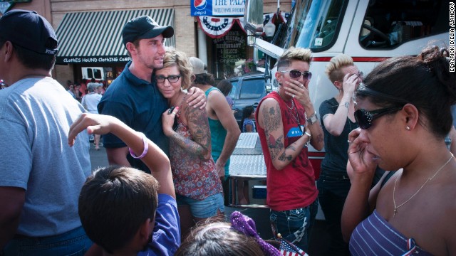 Mourners grieve as they welcome home the procession. The firefighters died after deploying emergency shelters as the fast-moving forest fire suddenly changed direction on June 30. 