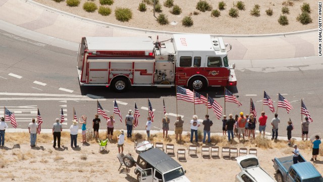 A fire truck travels as part of the procession under escort by the Joint Arizona Honor Guard.