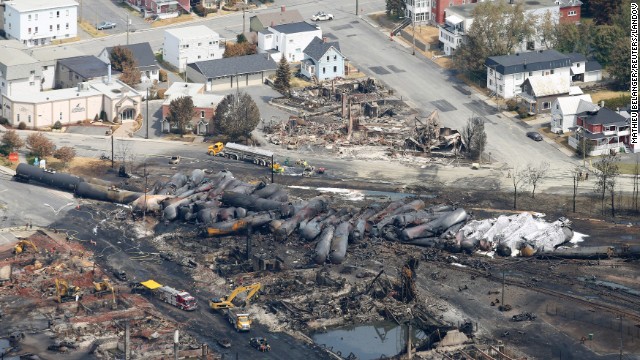 Burned tanker cars are scattered on the tracks in Lac-Megantic, Quebec, on Monday, July 8. On Saturday, July 6, the train, pulling tankers of crude oil, rolled into the town unattended from 7 miles away, derailed and exploded.