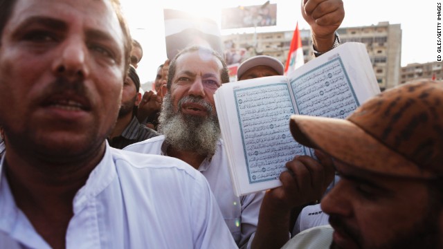 A Morsy supporter holds up the Quran in Nasr City on July 8.