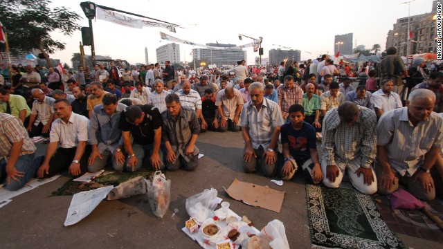 Egyptians in Cairo's Tahrir Square pray before breaking their fast on the third day of Ramadan, the sacred holy month for Muslims, on Friday, July 12. 