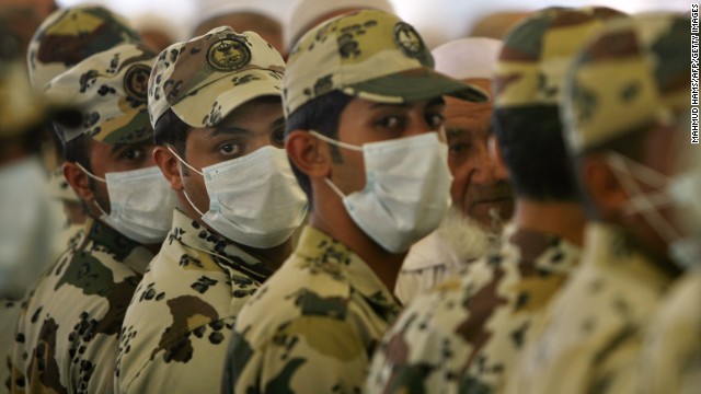 Saudi policemen, wearing protective masks against swine flu, stand guard near the holy city of Mecca on November 28, 2009.