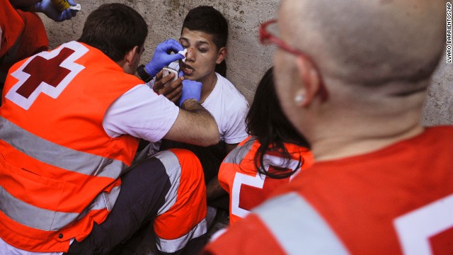 An injured man receives medical attention outside of the bull ring on July 13.