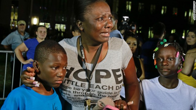 Darrsie Jackson cries and comforts her children Linzey Stafford, left, 10, and Shauntina Stafford, 11, outside the courthouse on July 13.
