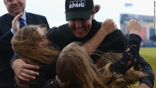 Phil Mickelson hugs his three children after winning the Scottish Open in a playoff at Castle Stuart. 
