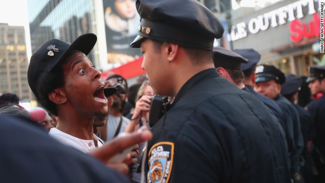 A man argues with a police officer as supporters of Trayvon Martin march while blocking traffic in Union Square in New York on Sunday, July 14. A jury acquitted George Zimmerman of all charges related to the shooting death of Martin. <a href='http://www.cnn.com/2013/06/27/justice/gallery/zimmerman-trial/index.html'>View photos of key moments from the trial.</a>