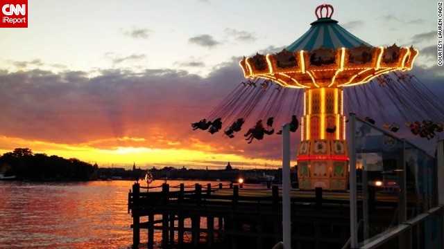 Visitors to <a href='http://ireport.cnn.com/docs/DOC-991757'>Tivoli Grona Lund</a> amusement park ride the flying swings as Sweden's summer sun sets around 10:30 p.m.