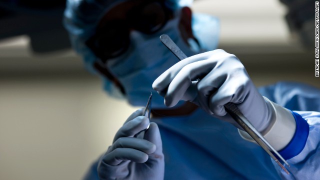 Dr. Niraj Desai orients a suture during a kidney transplant at Johns Hopkins Hospital in Baltimore.