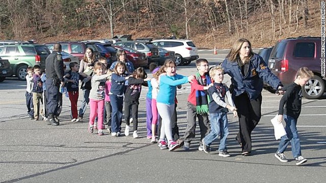 Connecticut State Police evacuate children from Sandy Hook Elementary School in Newtown, Connecticut, on December 14, 2012. Adam Lanza opened fire in the school, killing 20 children and six adults before killing himself. Police say he also shot and killed his mother in her Newtown home. 