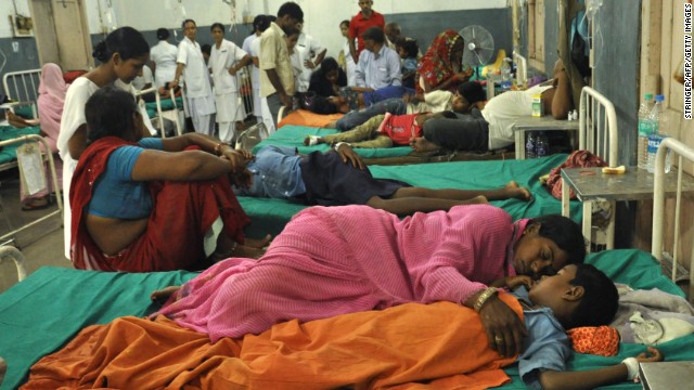 A woman rests with her child at a ward housing the poisoned schoolchildren at the Patna Medical College and Hospital, in the eastern Indian state of Bihar, Wednesday, July 17. At least 22 schoolchildren died in northeastern India after eating free school lunches that contained an insecticide commonly used in agriculture. Officials are investigating whether the poisoning was accidental or deliberate. 