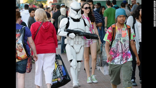 Myke Soler walks outside the San Diego Convention Center dressed as a "Star Wars" stormtrooper with his wife during Comic-Con International 2013 on Wednesday, July 17, in San Diego, California. Started in 1970, the event is estimated to bring well over 100,000 attendees.