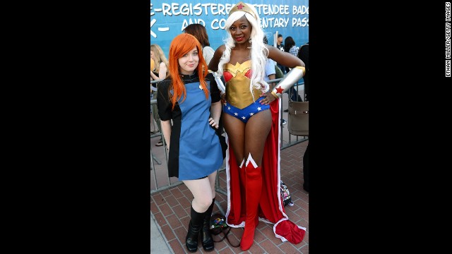 Rachel Elsten, left, dressed in a Star Trek uniform and Chaka Cumberbatch, dressed as Wonder Woman, pose outside the convention center.